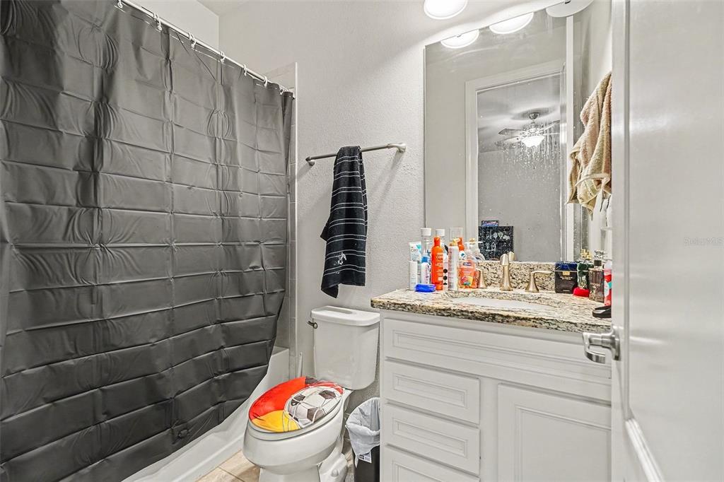 12593 Palapa Loop Spring Hill, FL 34610 - Photo 13 of 21 a bathroom with a sink toilet vanity and mirror