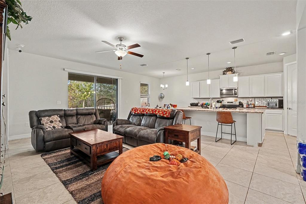 12593 Palapa Loop Spring Hill, FL 34610 - Photo 4 of 21 a living room with furniture kitchen view and a large window