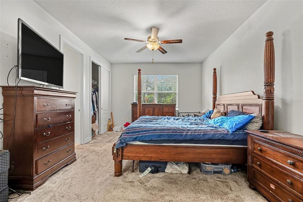 12593 Palapa Loop Spring Hill, FL 34610 - Photo 9 of 21 a bedroom with furniture and flat screen tv