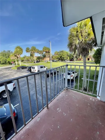 a view of a patio with wooden floor and outer view