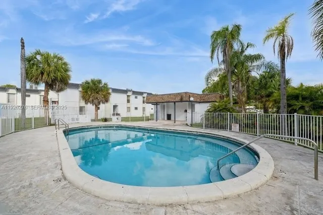 a front view of a house with a garden and trees