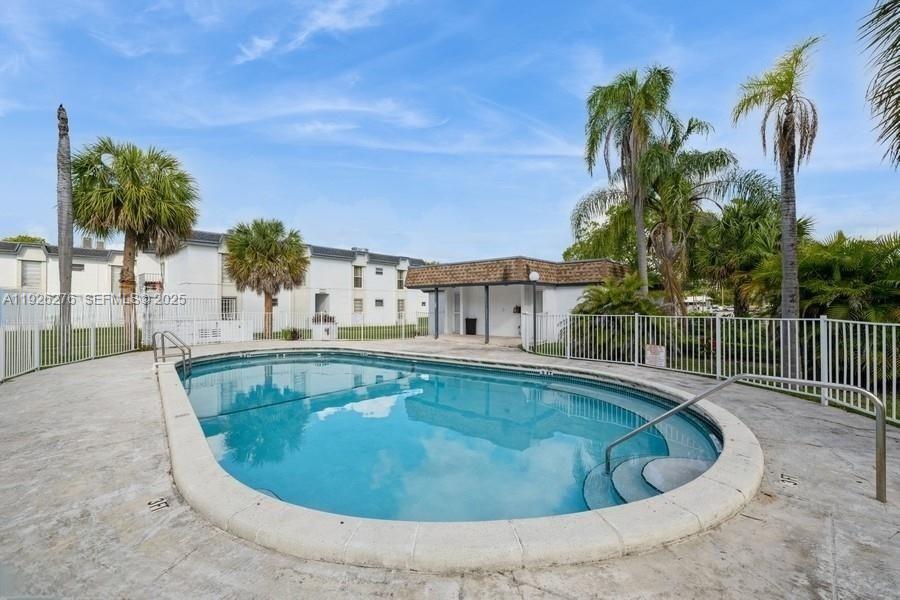 7250 Southwest 94th Place, Unit B6 Miami, FL 33173 - Photo 17 of 23 a view of a swimming pool with a patio