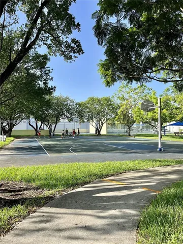 a view of sign board with a house in the background
