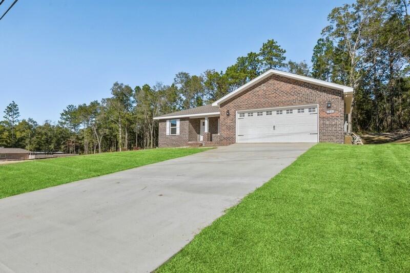 3933 Poverty Creek Road Crestview, FL 32539 - Photo 3 of 32 a front view of a house with a yard
