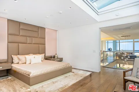 a bedroom with a large bed and a couch