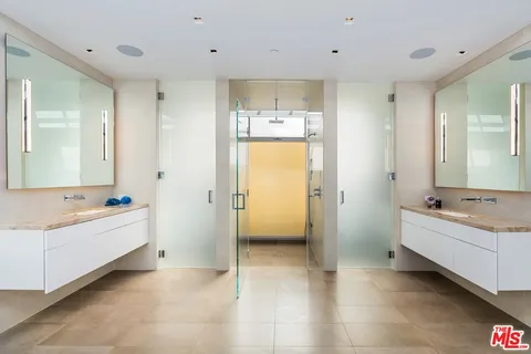 a view of a hallway with wooden floor and windows