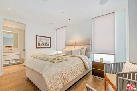 a bedroom with a bed and a lamp