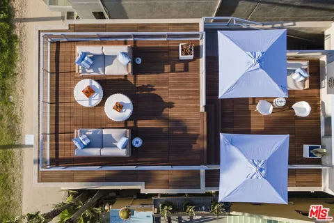 a view of outdoor seating space with furniture and wooden floor