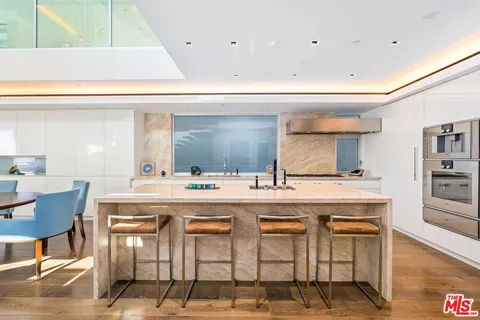 a kitchen with a table and chairs in it