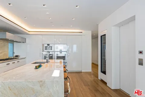 a kitchen with stainless steel appliances a sink and a refrigerator