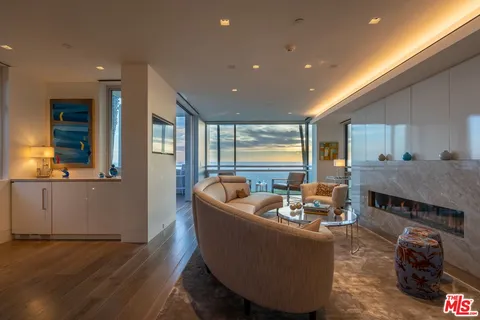 a living room with furniture and a floor to ceiling window