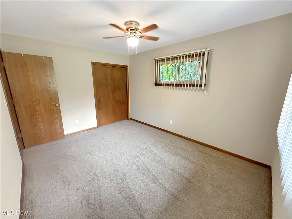 596 Hadcock Road Brunswick, OH 44212 - Photo 15 of 17 Unfurnished bedroom with closet, light carpet, and a ceiling fan
