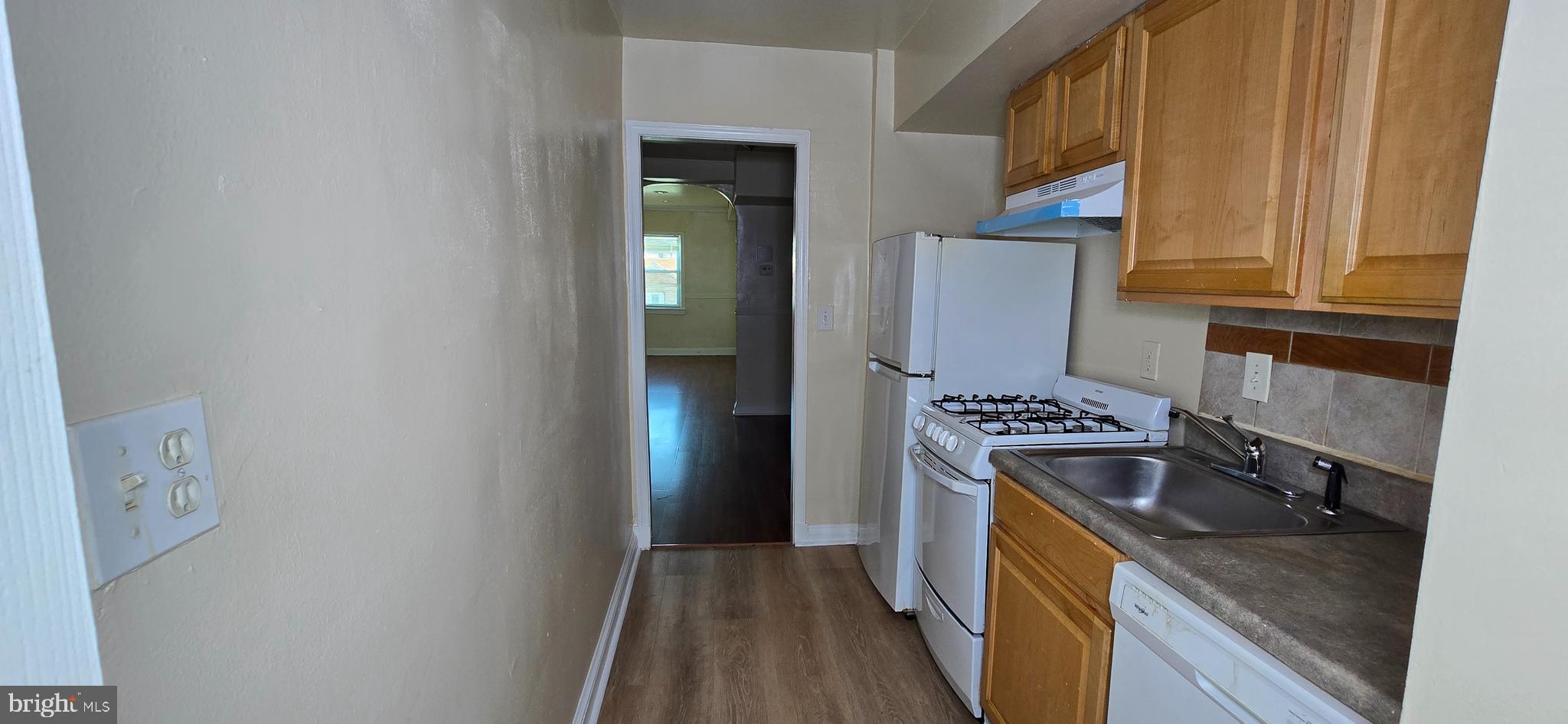 1255 Meigs Place Northeast, Unit 4 Washington, DC 20002 - Photo 13 of 15 a kitchen with granite countertop a stove and refrigerator