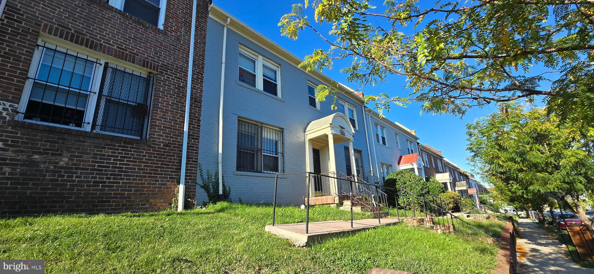 1255 Meigs Place Northeast, Unit 4 Washington, DC 20002 - Photo 2 of 15 a front view of a house with a yard