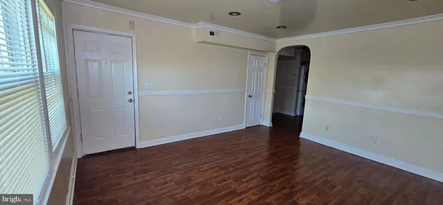 an empty room with wooden floor