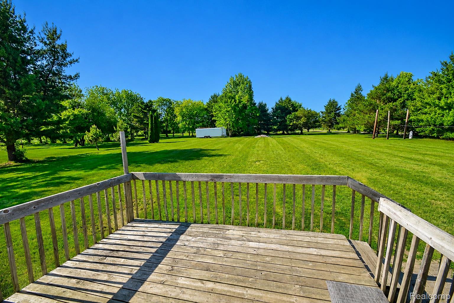 5424 Cook Road Swartz Creek, MI 48473 - Photo 15 of 15 Expansive outdoor deck with natural wood planks and railings