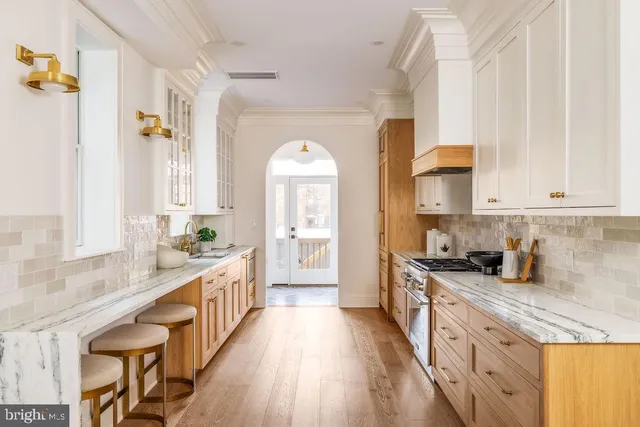 a kitchen with stove and cabinets