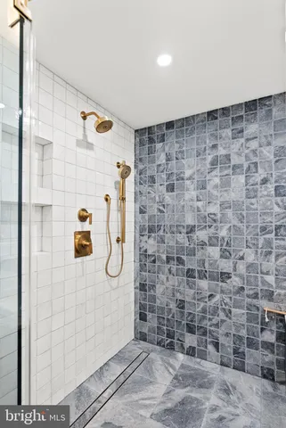 a bedroom with bed and a chandelier