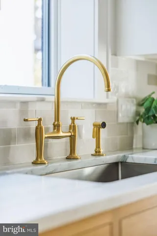 a bathroom with a granite countertop bathtub shower sink vanity and toilet