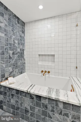 a bathroom with a double vanity sink toilet and a mirror