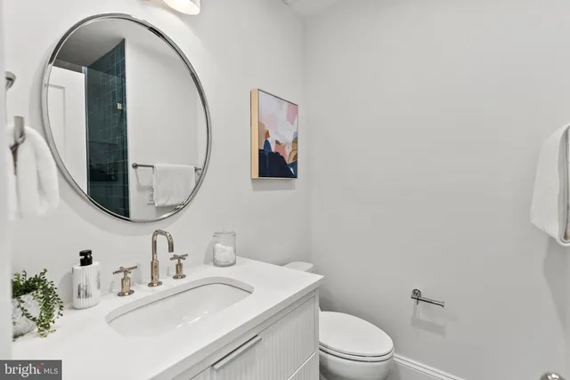 a living room with furniture lamp and a rug