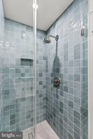 a kitchen with a white stainless steel appliances and wooden floor