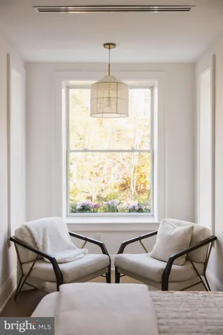 a view of staircase with white walls and a window