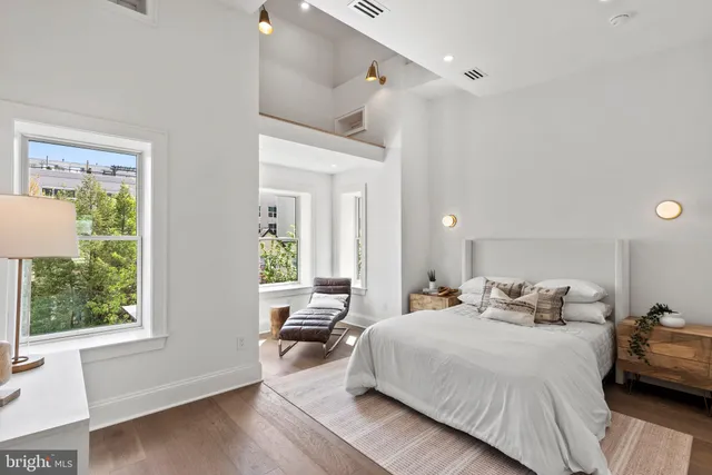 a bathroom with a granite countertop toilet a sink and a mirror