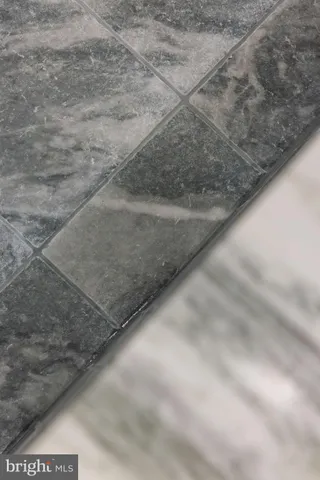 a bathroom with a granite countertop sink a toilet and a mirror