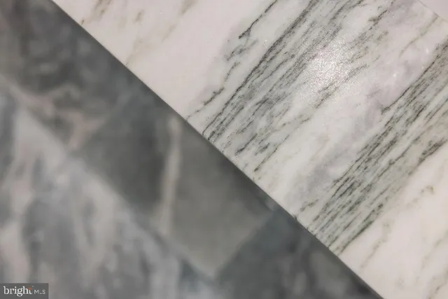 a bedroom with a bed and painting on the wall