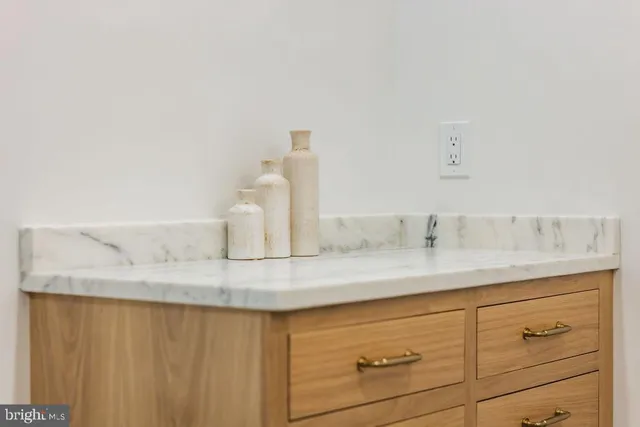 a view of a balcony with chairs and a potted plant