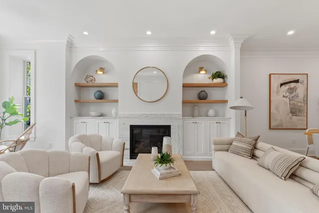 a living room with furniture a fireplace and a large window