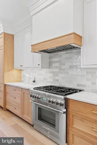 a large kitchen with stainless steel appliances lots of counter space and a sink