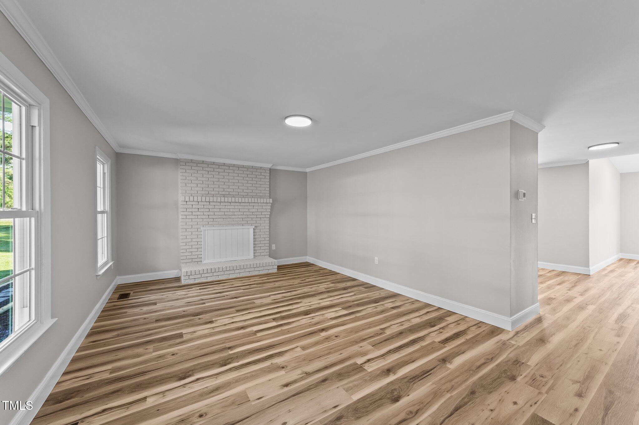 620 Richardson Road Zebulon, NC 27597 - Photo 12 of 52 a view of a livingroom with wooden floor and window