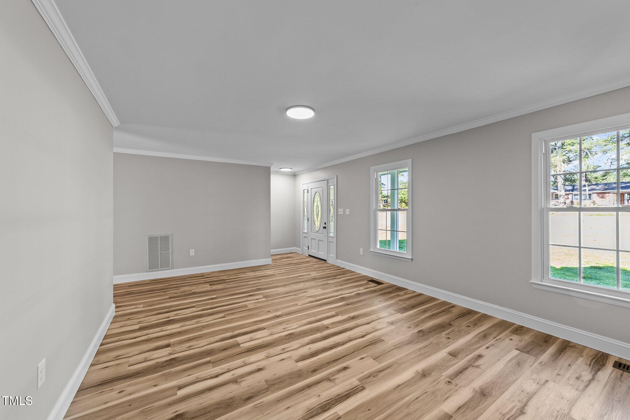 620 Richardson Road Zebulon, NC 27597 - Photo 13 of 52 a view of empty room with wooden floor and fan