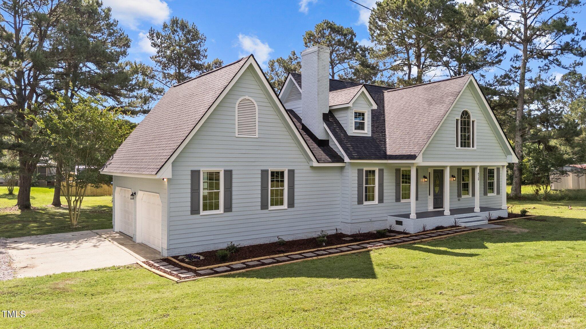 620 Richardson Road Zebulon, NC 27597 - Photo 2 of 52 a view of a white house with a swimming pool and a yard