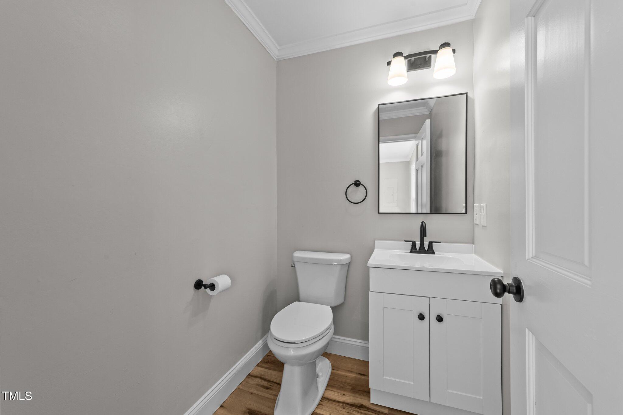 620 Richardson Road Zebulon, NC 27597 - Photo 22 of 52 a bathroom with a toilet sink and mirror