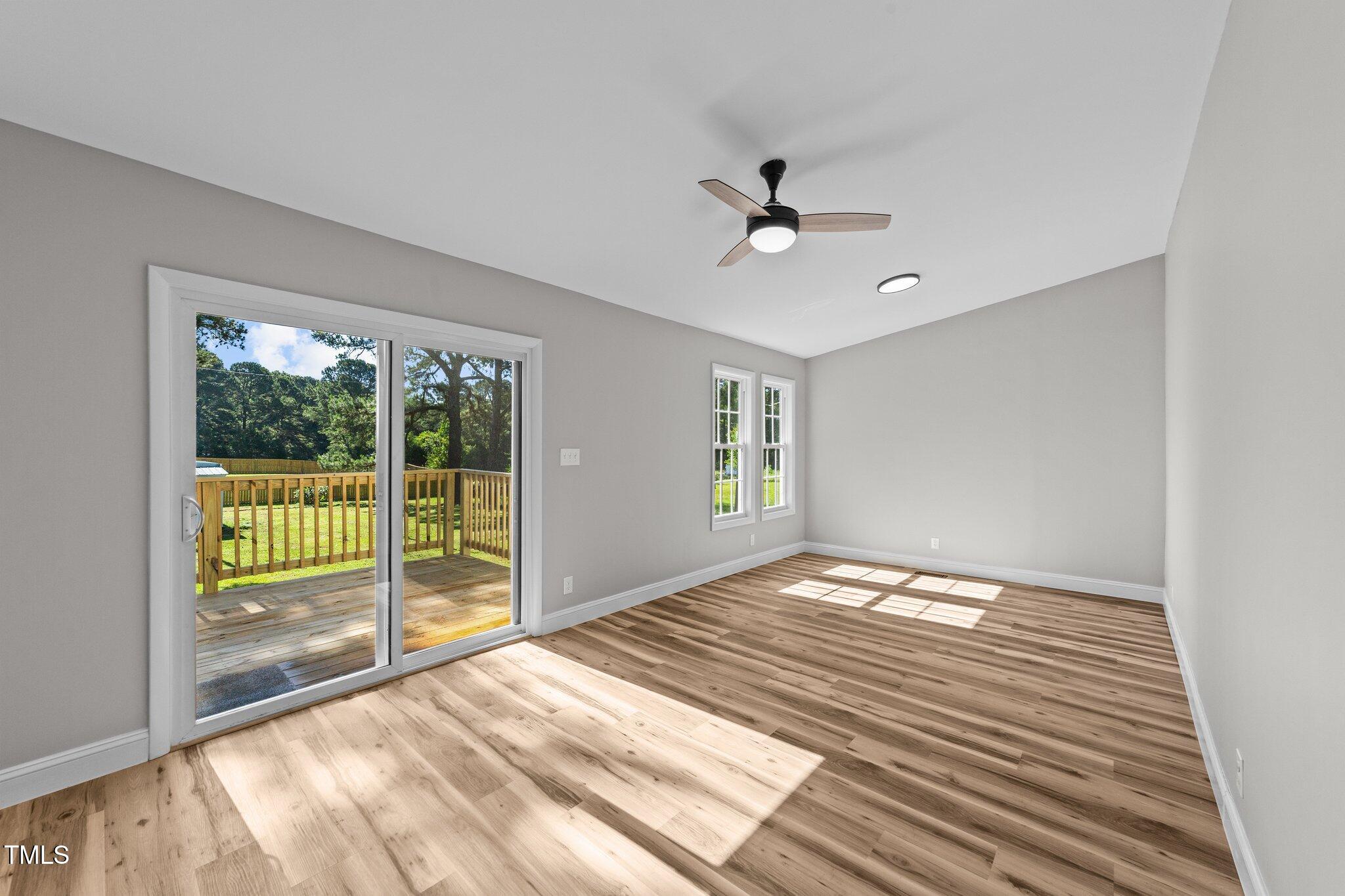 620 Richardson Road Zebulon, NC 27597 - Photo 24 of 52 a view of empty room with wooden floor and fan