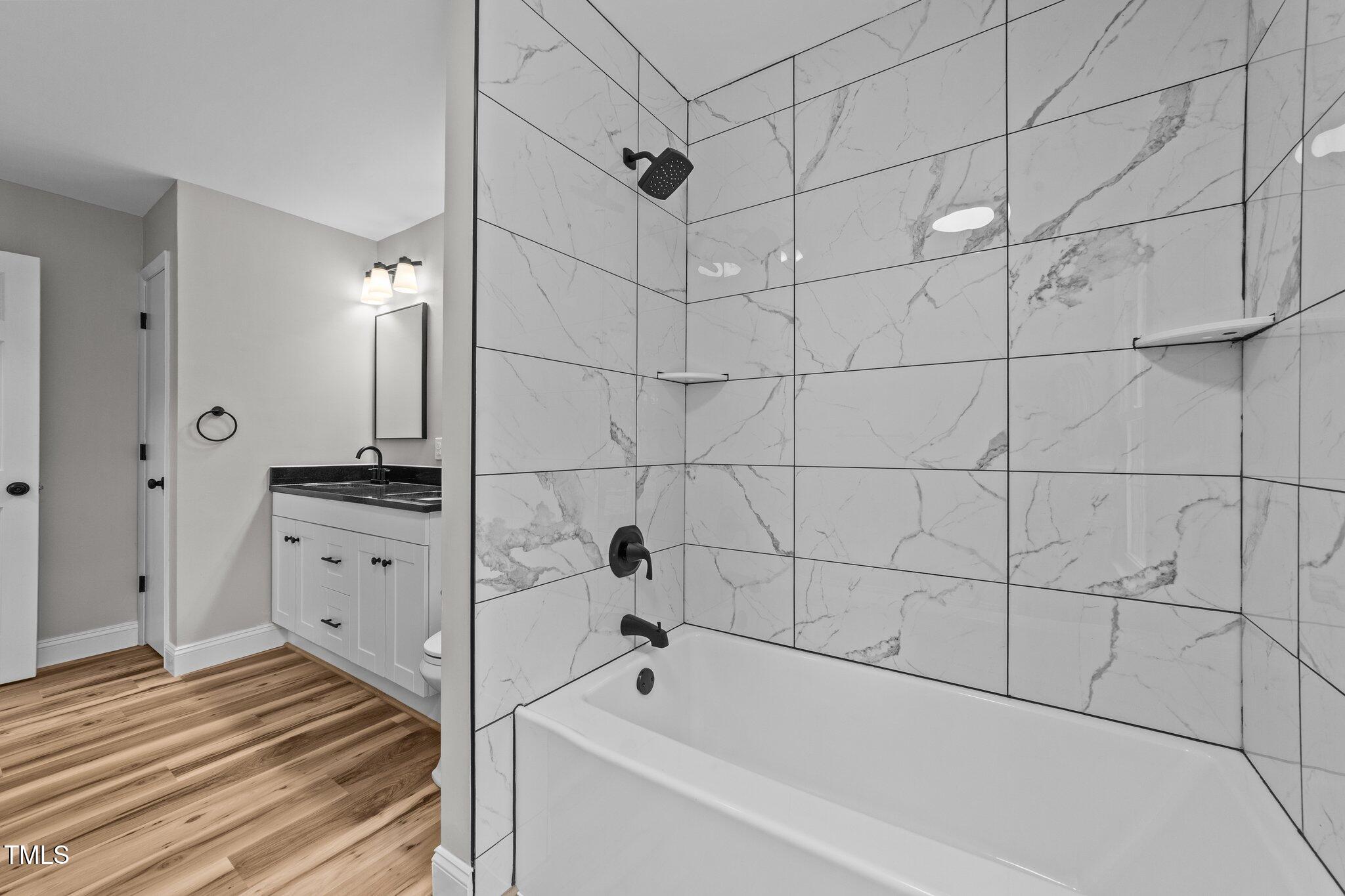 620 Richardson Road Zebulon, NC 27597 - Photo 27 of 52 a bathroom with a bathtub and a shower