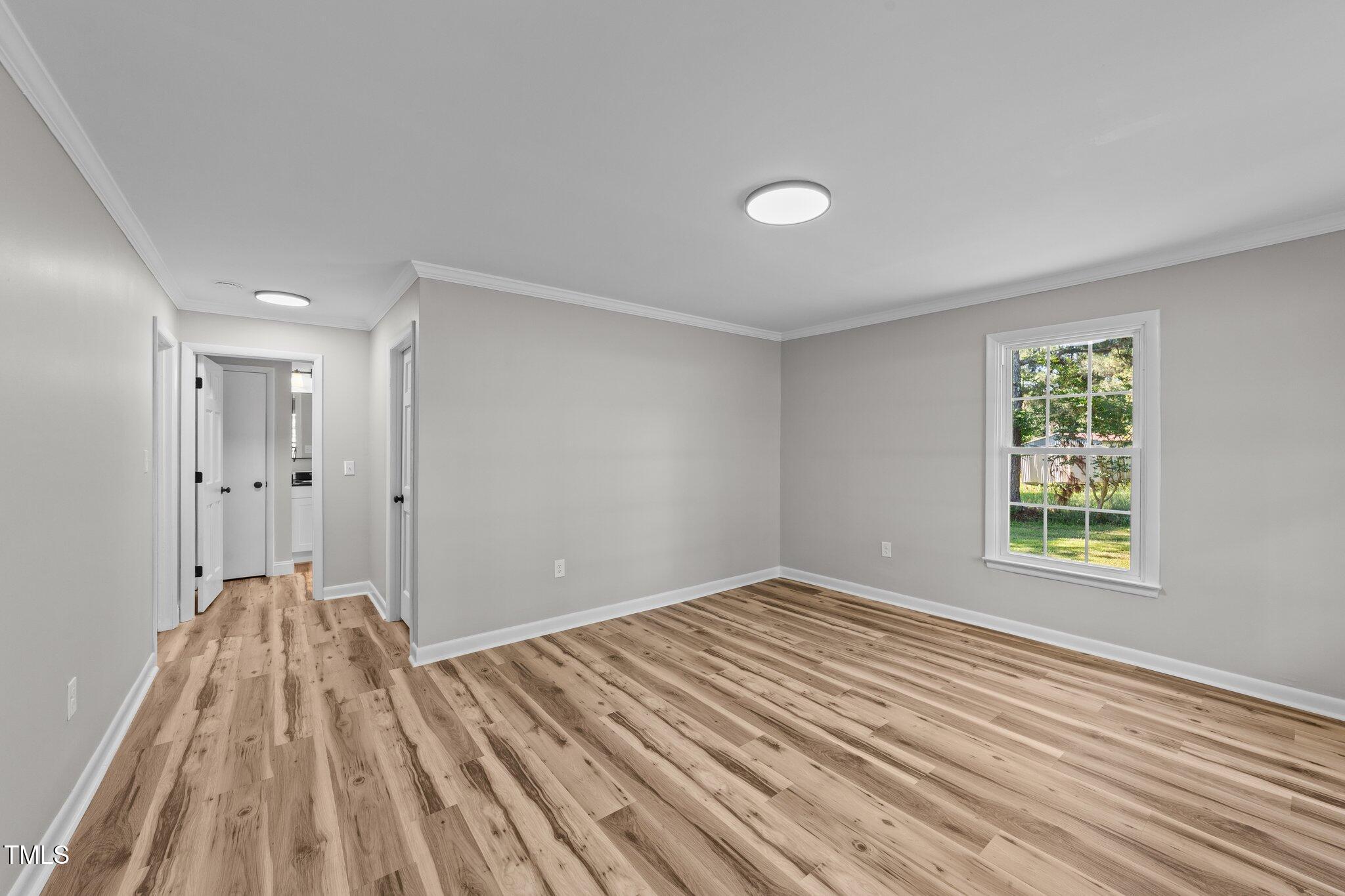 620 Richardson Road Zebulon, NC 27597 - Photo 29 of 52 a view of a room with wooden floor and a window