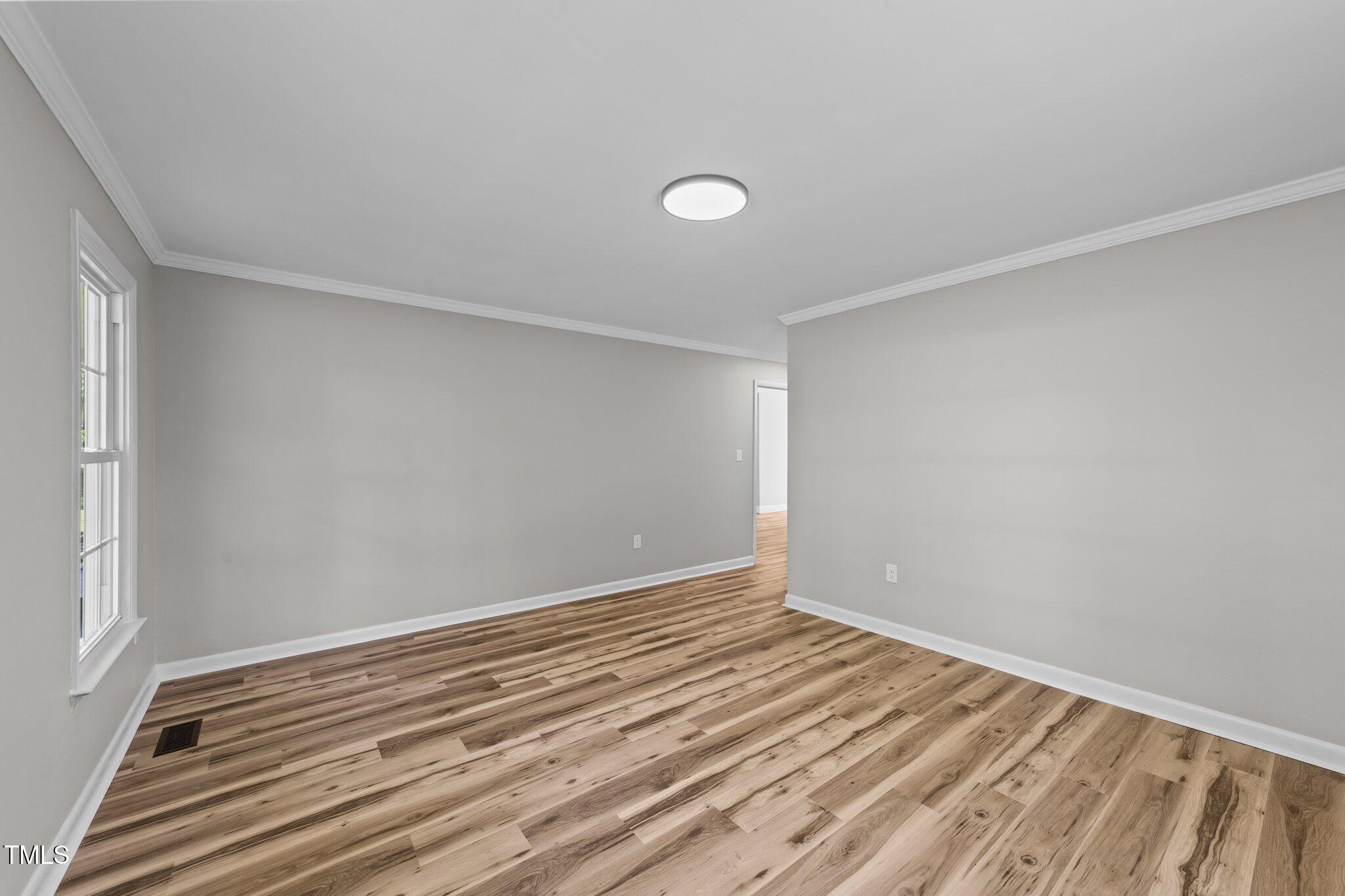 620 Richardson Road Zebulon, NC 27597 - Photo 30 of 52 a view of room with wooden floor and fan