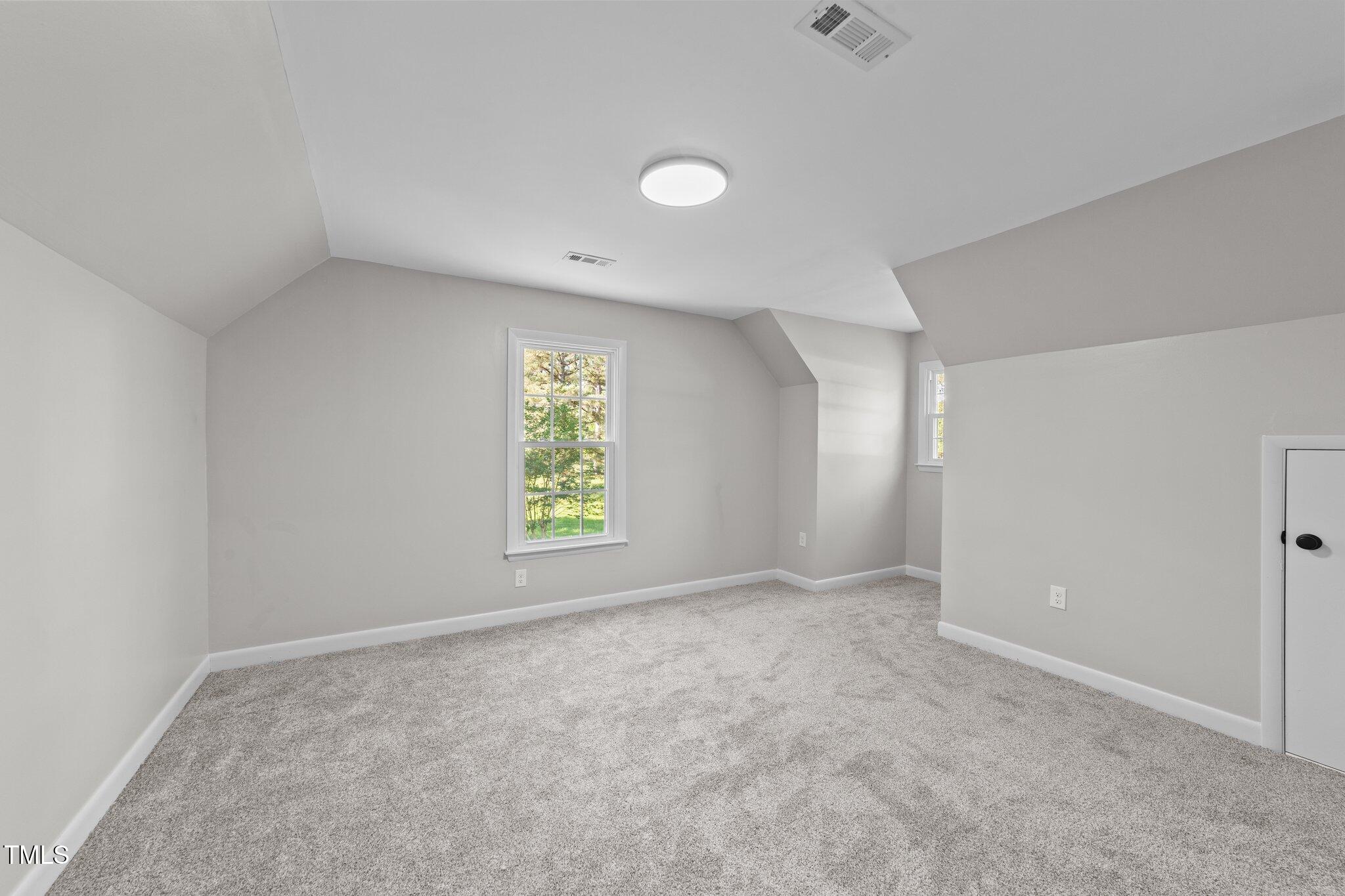 620 Richardson Road Zebulon, NC 27597 - Photo 34 of 52 an empty room with windows