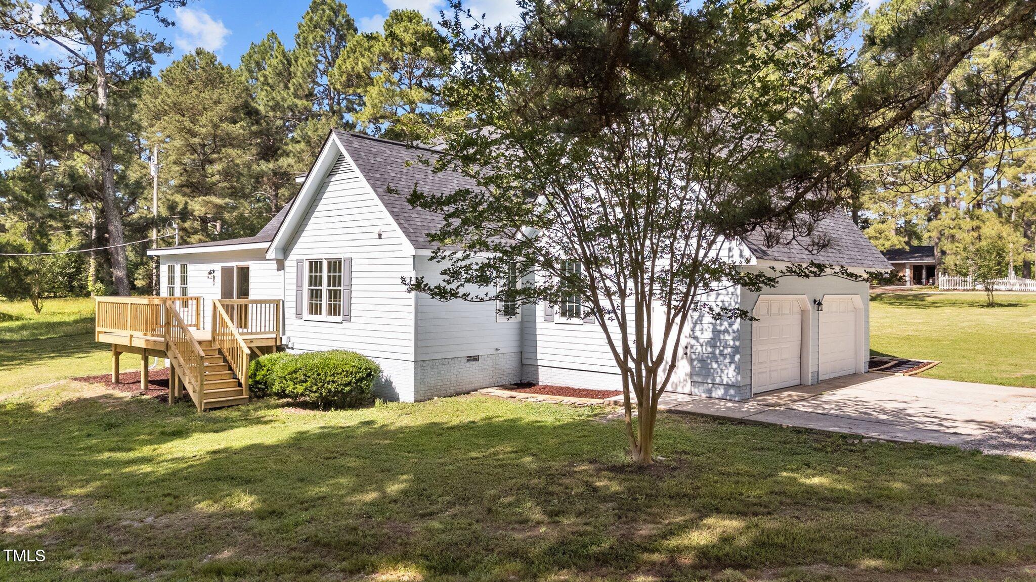 620 Richardson Road Zebulon, NC 27597 - Photo 45 of 52 a view of a house with backyard and tree