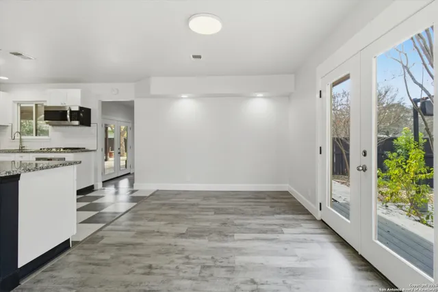 a view of kitchen with stainless steel appliances a refrigerator and a stove top oven