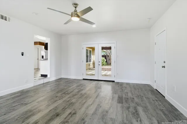 wooden floor in an empty room with a window
