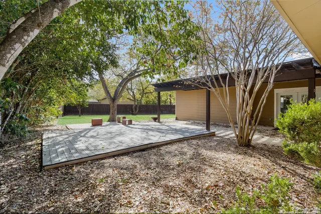 a view of a backyard with large trees