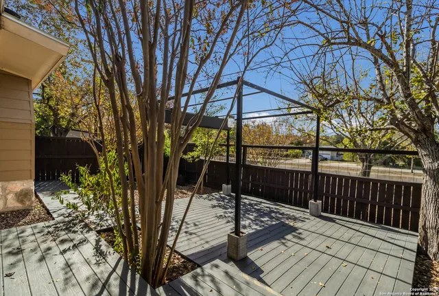 a view of a balcony with wooden floor and outdoor space