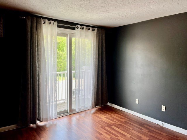 41 Leonard Road, Unit 41 Boxborough, MA 01719 - Photo 7 of 7 a view of an empty room with wooden floor and a window