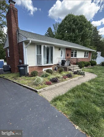 a front view of a house with yard patio and green space