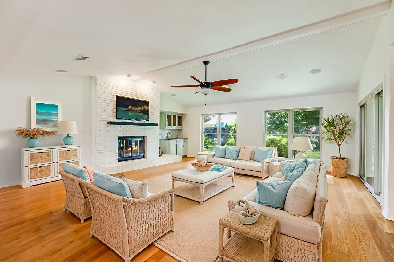 a living room with fireplace furniture and a wooden floor